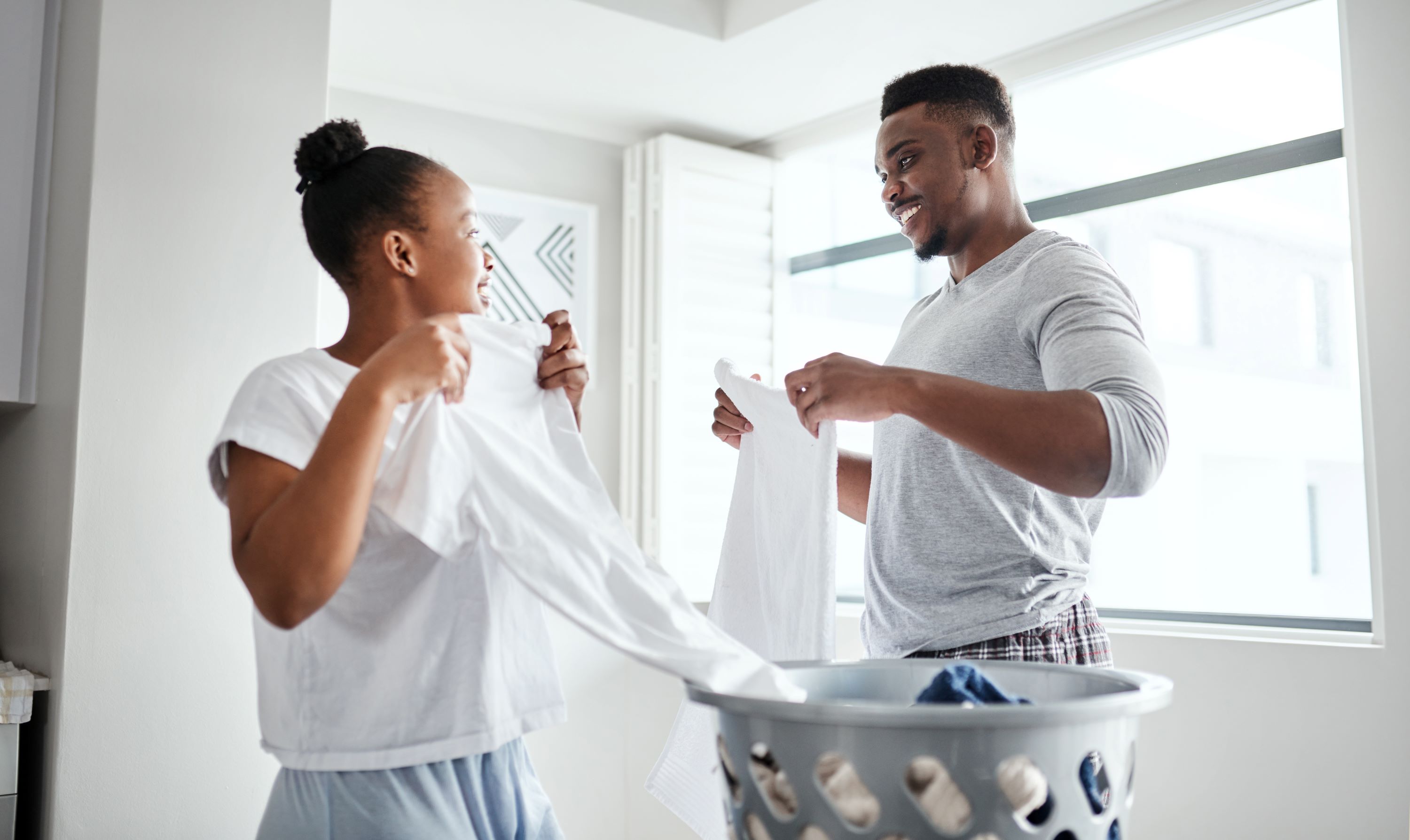 Couple Doing Laundry Shutterstock 2146083771